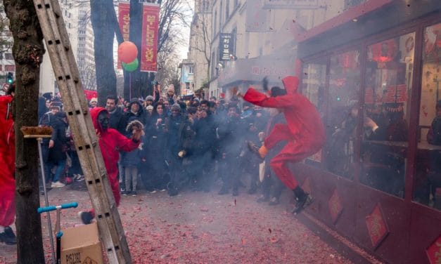 Dancer in red leaping through the smoke